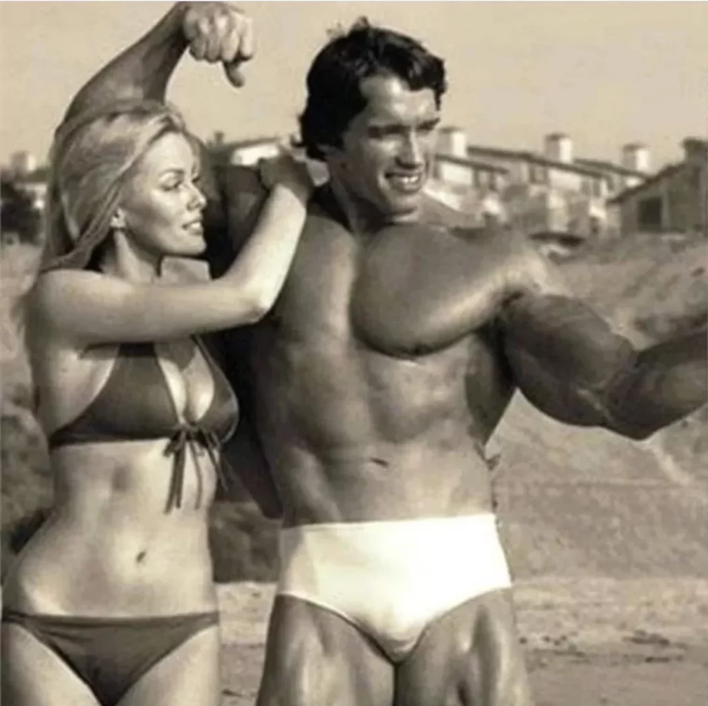 Arnold posing with a beautiful lady