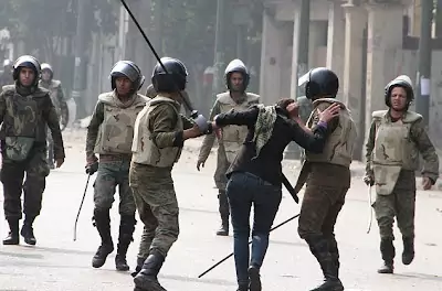 The heavy handed Egyptian army soldiers drag the arrested a woman protester off by her hair